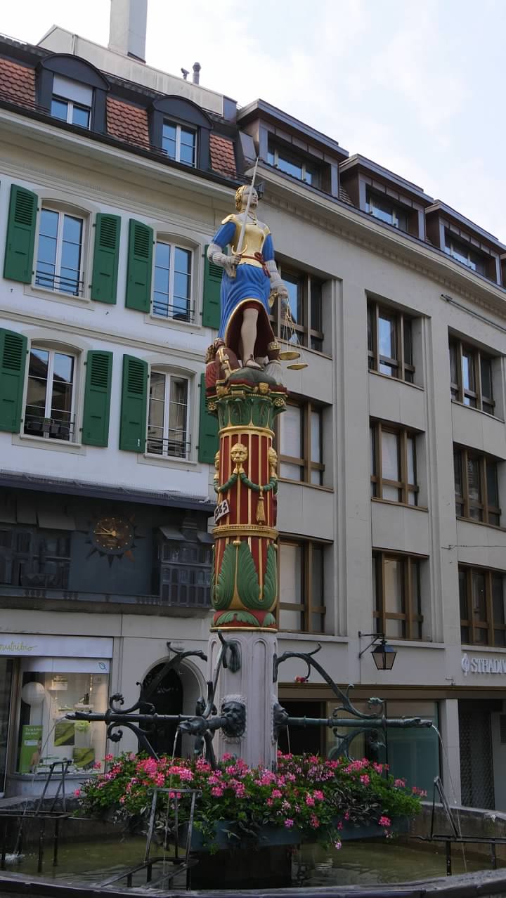 The fountain at Place de la Palud topped by the statue of Justice
