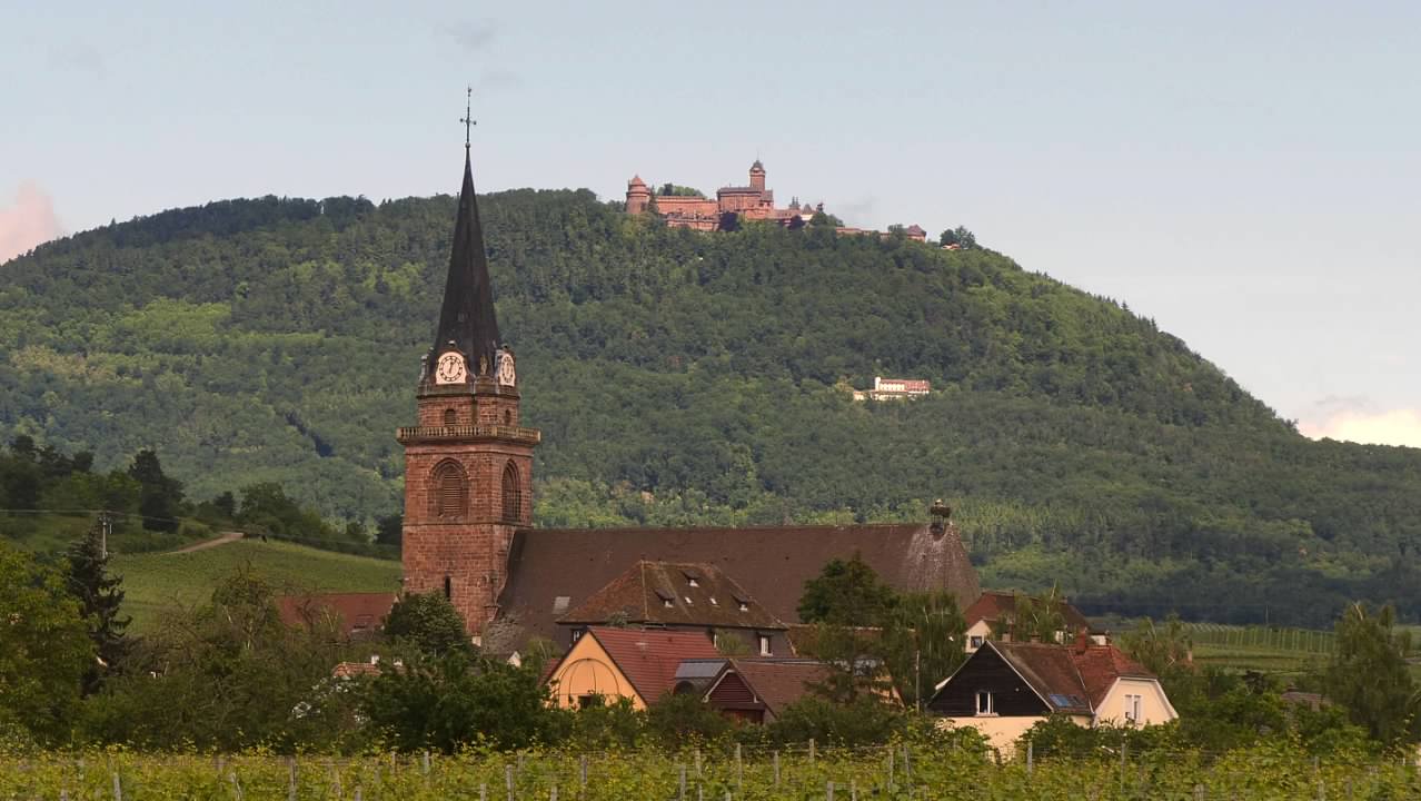 Church with  Château du Haut-Kœnigsbourg on the mountaintop